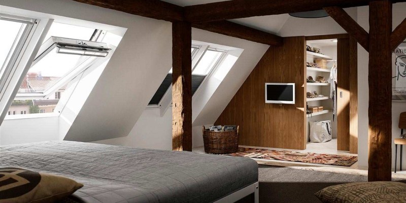 wood panelled bedroom in converted loft with several velux windows