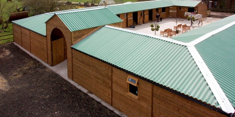 Equestrian stables roofed with green fibre cement roofing sheets