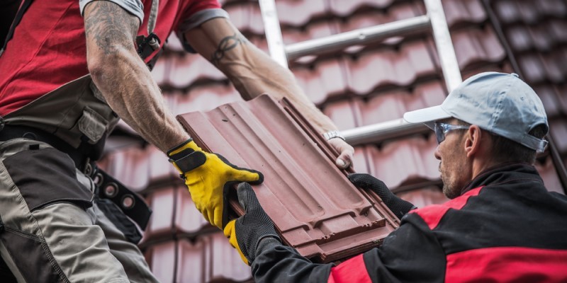 Tradesmen passing each other roof tiles